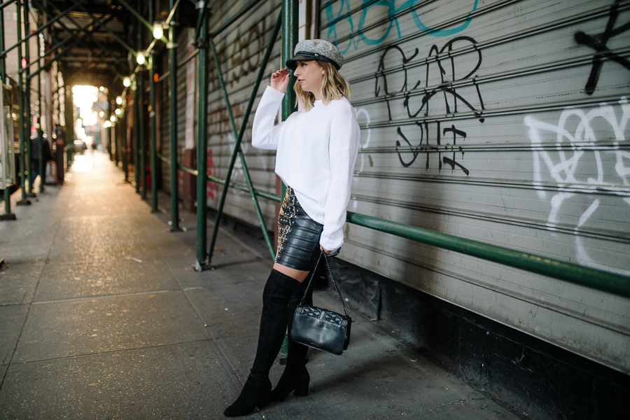 NYC Blogger, Rebecca Minkoff crossbody, Over the knee black boots, newsboy cap, pay phone, Hells Kitchen NYC, white sweater, chic fall fashion, fall outfit, white and black outfit, edgy fashion