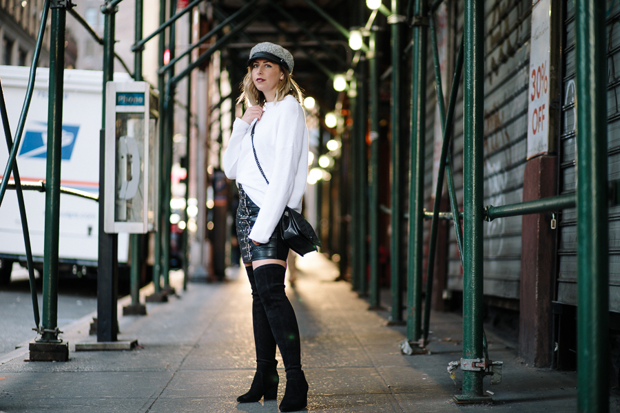 NYC Blogger, Rebecca Minkoff crossbody, Over the knee black boots, newsboy cap, pay phone, Hells Kitchen NYC, white sweater, chic fall fashion, fall outfit, white and black outfit, edgy fashion