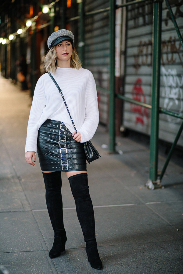 NYC Blogger, Rebecca Minkoff crossbody, Over the knee black boots, newsboy cap, pay phone, Hells Kitchen NYC, white sweater, chic fall fashion, fall outfit, white and black outfit, edgy fashion, misguided leather skirt